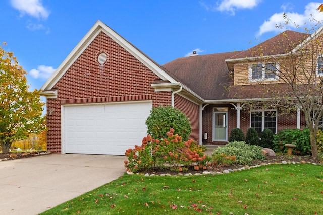 view of property with a front yard and a garage