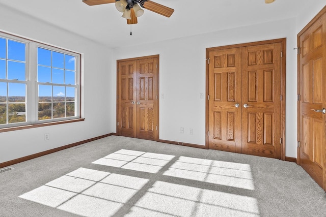 unfurnished bedroom featuring ceiling fan and light carpet