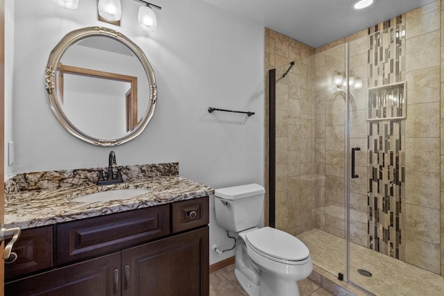 bathroom with toilet, a shower with door, tile patterned floors, and vanity