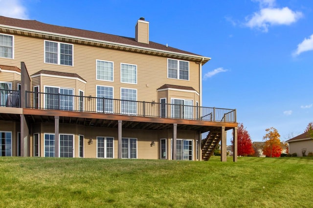 back of house with a deck and a lawn