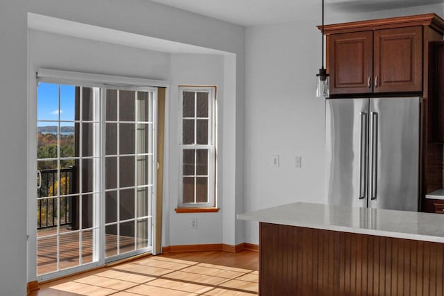 kitchen with high end refrigerator and light hardwood / wood-style flooring