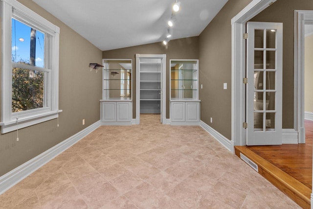 interior space featuring lofted ceiling and track lighting