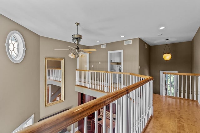 hallway with hardwood / wood-style floors