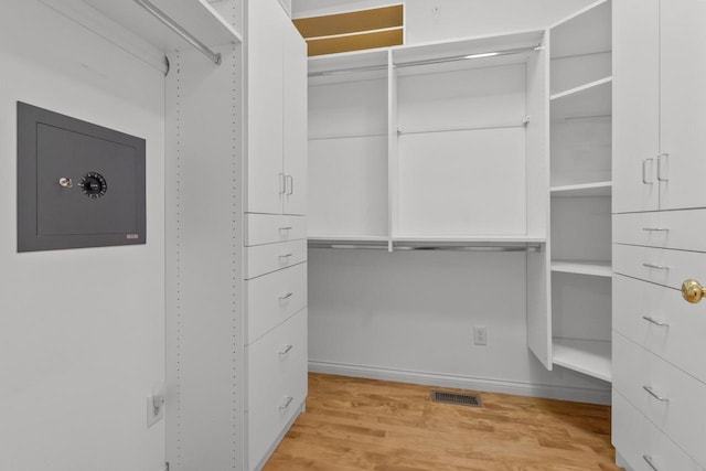 spacious closet featuring light hardwood / wood-style floors