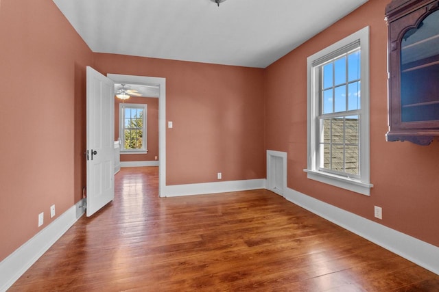 spare room featuring hardwood / wood-style floors and ceiling fan