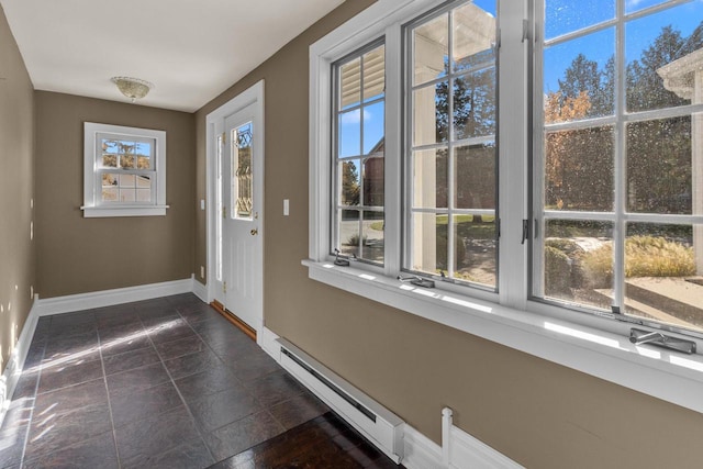 doorway to outside featuring dark tile patterned floors and a baseboard radiator