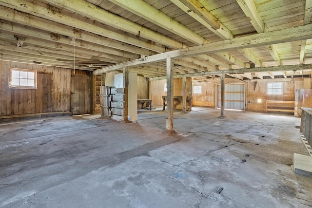 misc room featuring wooden walls