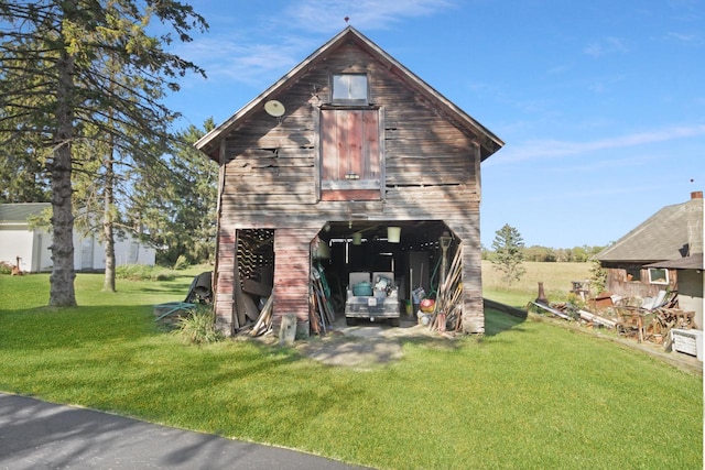 view of outdoor structure featuring a lawn