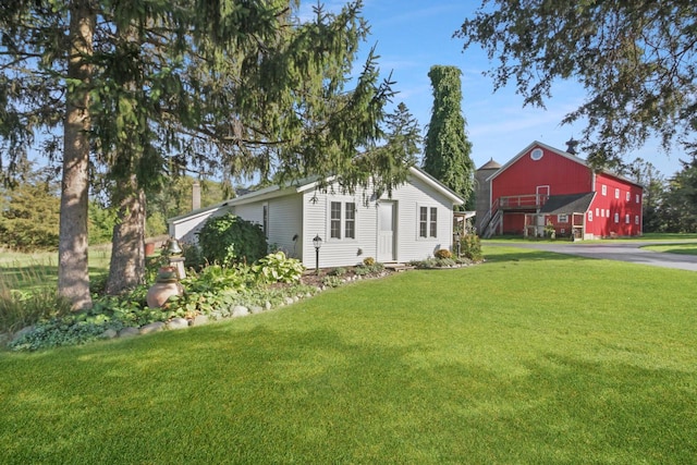 view of property exterior featuring a lawn