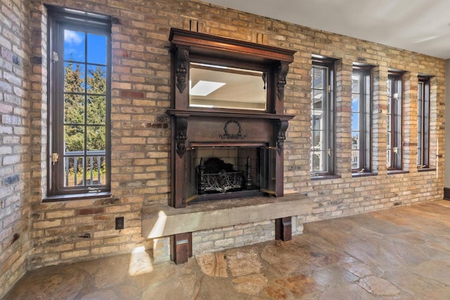 unfurnished living room with brick wall