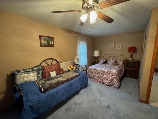 carpeted bedroom featuring ceiling fan