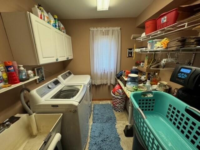 laundry area with cabinets and washing machine and dryer