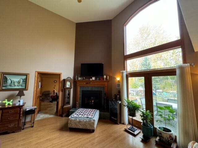 living room featuring light hardwood / wood-style flooring and a tiled fireplace