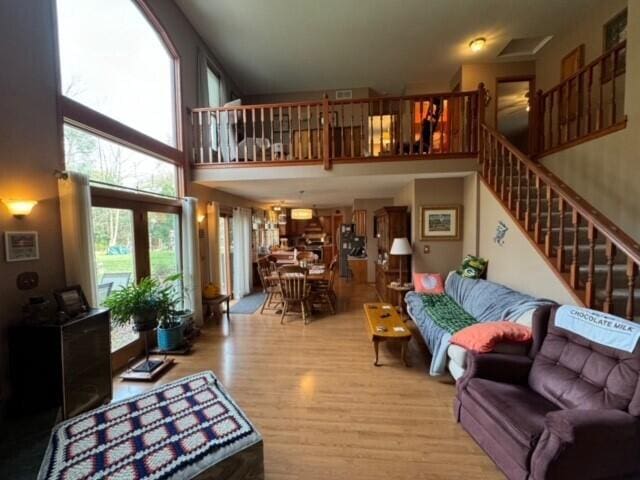 living room with a high ceiling and wood-type flooring