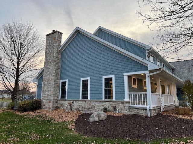 view of property exterior with a porch