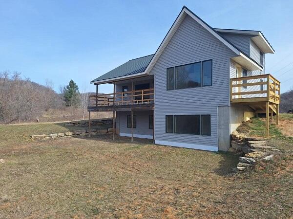 back of house with a yard and a deck