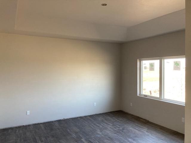 unfurnished room featuring dark hardwood / wood-style flooring