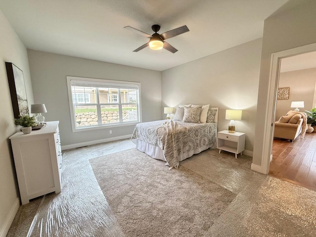 bedroom with wood-type flooring and ceiling fan