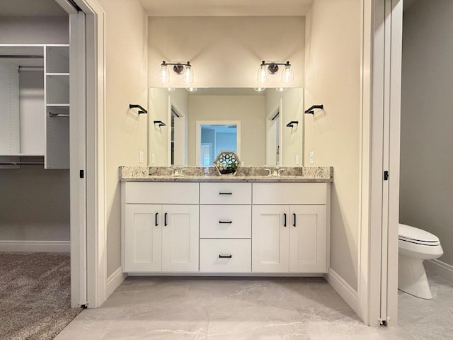 bathroom with vanity and toilet