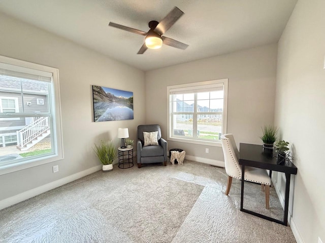 carpeted office space with ceiling fan