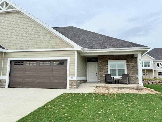 craftsman house with a front yard and a garage