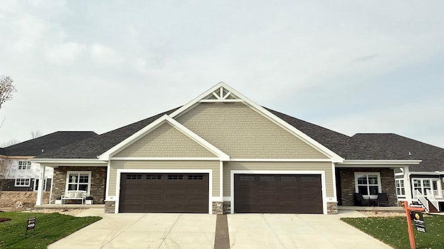 craftsman house with a front yard and a garage