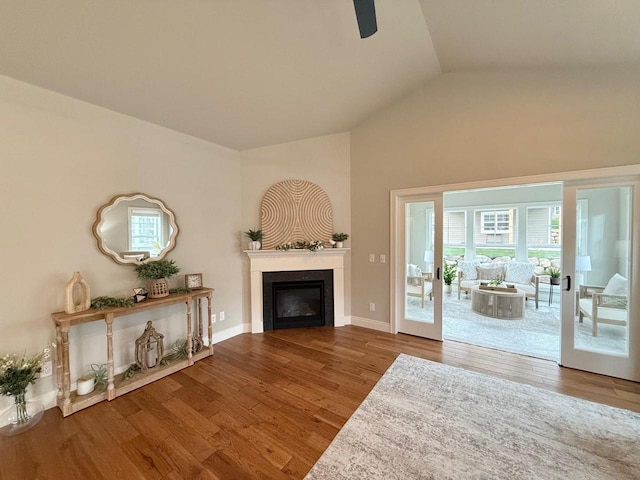 living room featuring hardwood / wood-style floors and vaulted ceiling