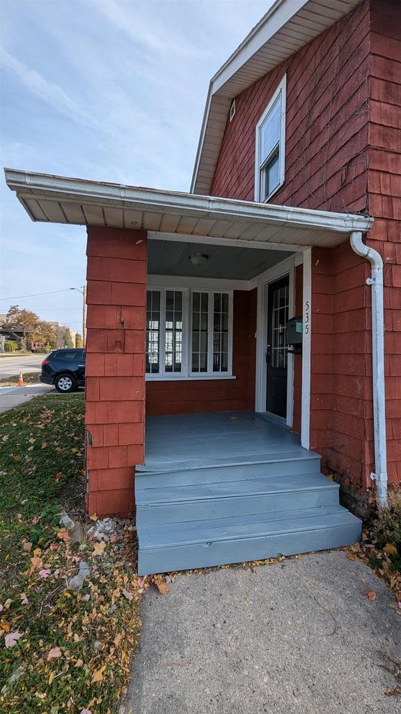 view of exterior entry featuring a porch