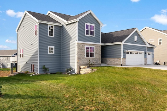 view of front of house with a garage and a front lawn