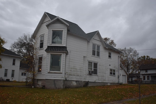 view of property exterior featuring cooling unit and a lawn