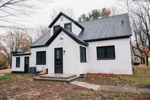 rear view of property with central AC