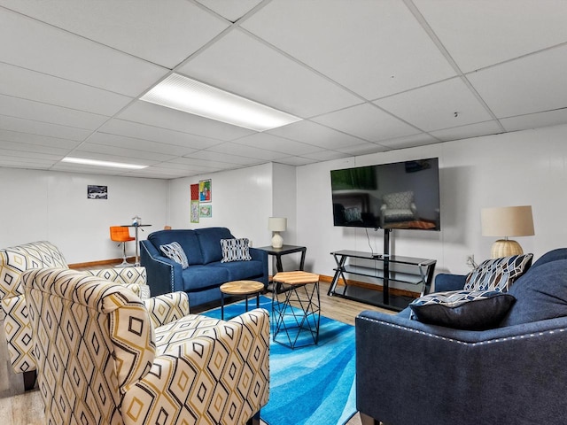 living room with wood-type flooring and a drop ceiling