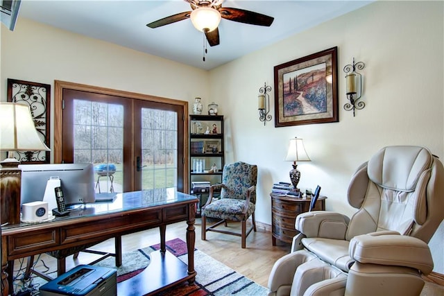 home office featuring french doors, ceiling fan, and light hardwood / wood-style flooring