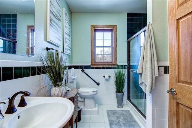 bathroom featuring toilet, tile walls, and an enclosed shower