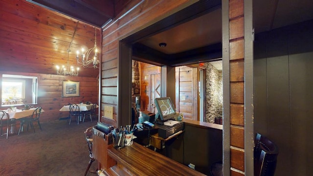 carpeted office space with a notable chandelier and wood walls