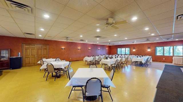 dining room featuring a drop ceiling and ceiling fan