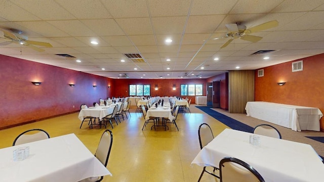 dining space featuring a drop ceiling and ceiling fan