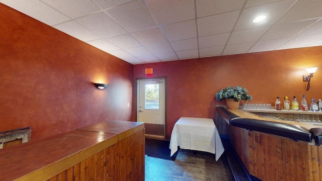 bedroom featuring indoor bar and a paneled ceiling