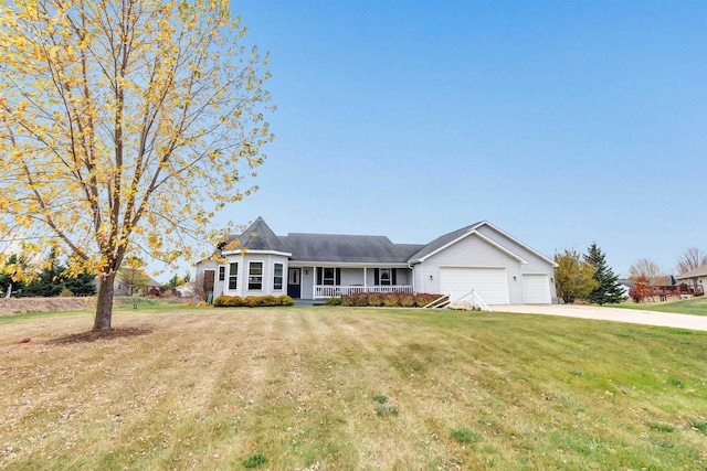 view of front of home with a porch, a front yard, and a garage