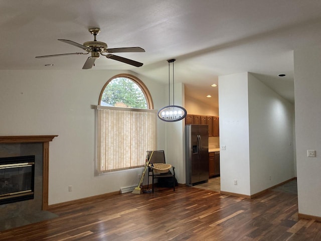 1524 Deer Brook Dr, Two Rivers, WI 54241 - unfurnished living room featuring vaulted ceiling, dark wood-style flooring, ceiling fan, baseboards, and a tile fireplace
