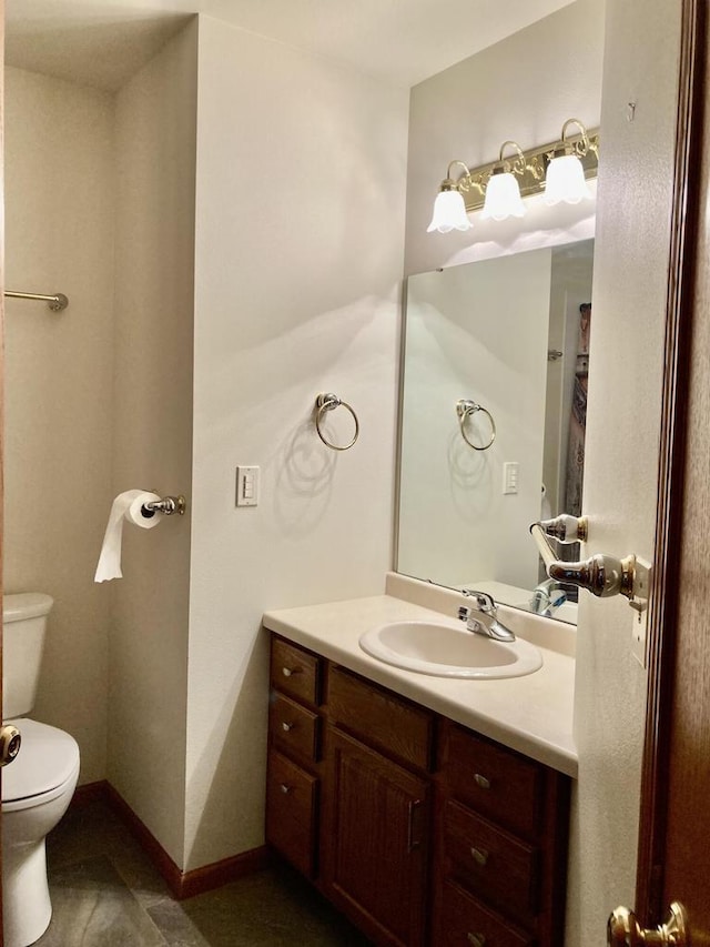 1524 Deer Brook Dr, Two Rivers, WI 54241 - bathroom featuring toilet, vanity, baseboards, and tile patterned floors