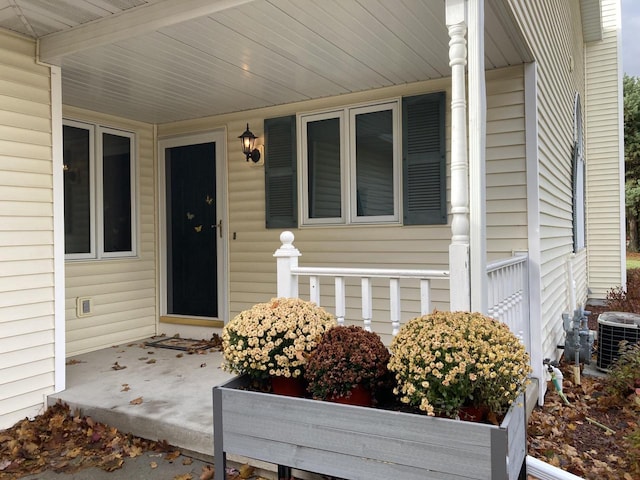 doorway to property with central AC and covered porch