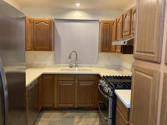 1524 Deer Brook Dr, Two Rivers, WI 54241 - kitchen featuring appliances with stainless steel finishes, a sink, light countertops, recessed lighting, and under cabinet range hood