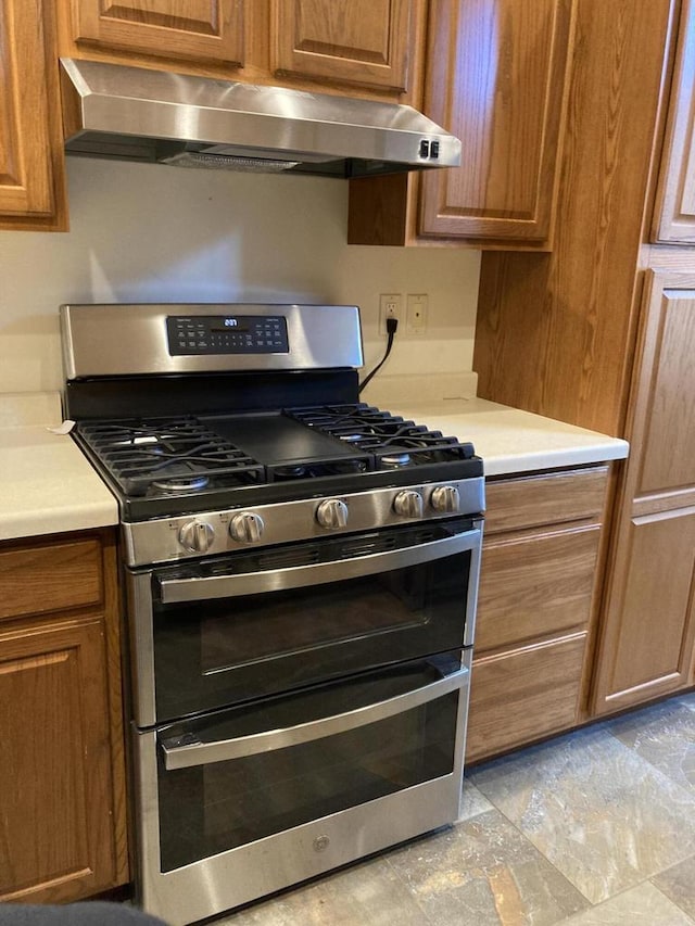1524 Deer Brook Dr, Two Rivers, WI 54241 - kitchen featuring range with two ovens, range hood, brown cabinets, and light countertops