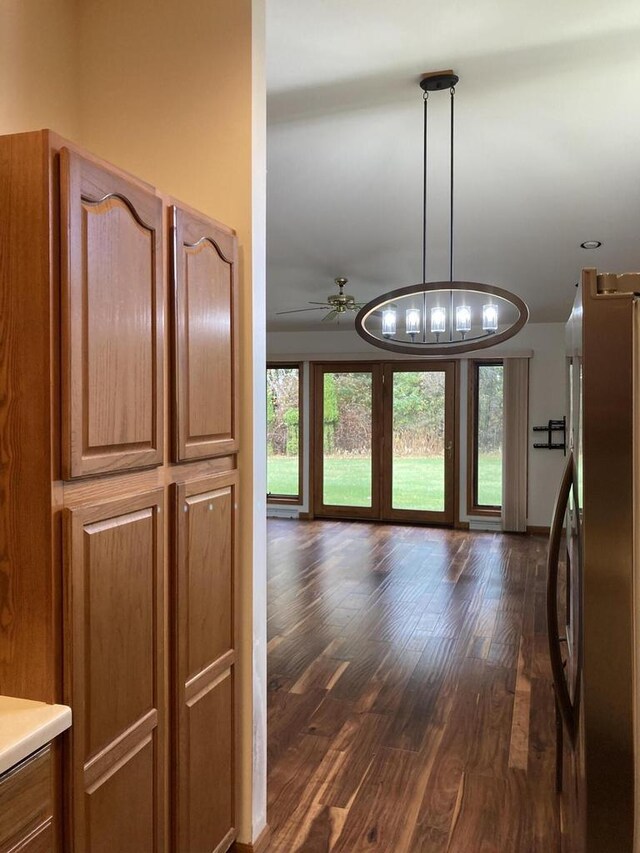 1524 Deer Brook Dr, Two Rivers, WI 54241 - kitchen featuring freestanding refrigerator, dark wood-style flooring, brown cabinets, and ceiling fan