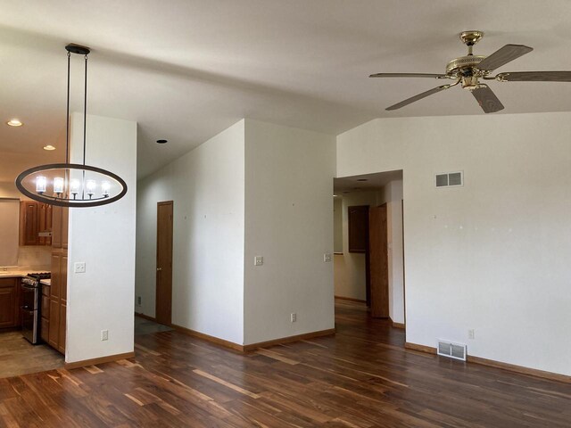 1524 Deer Brook Dr, Two Rivers, WI 54241 - unfurnished living room featuring wood finished floors, vaulted ceiling, baseboards, a chandelier, and ceiling fan