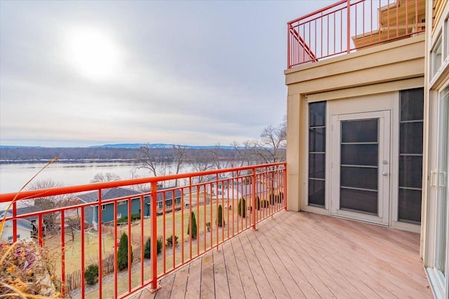 wooden terrace featuring a water view