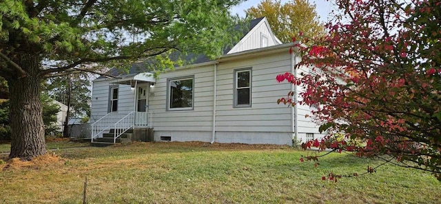 view of side of home with a lawn