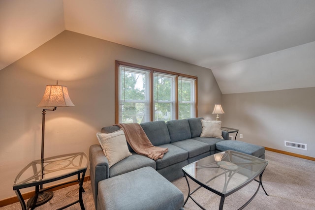 carpeted living room featuring lofted ceiling