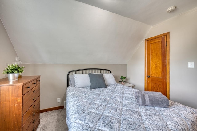 carpeted bedroom featuring vaulted ceiling